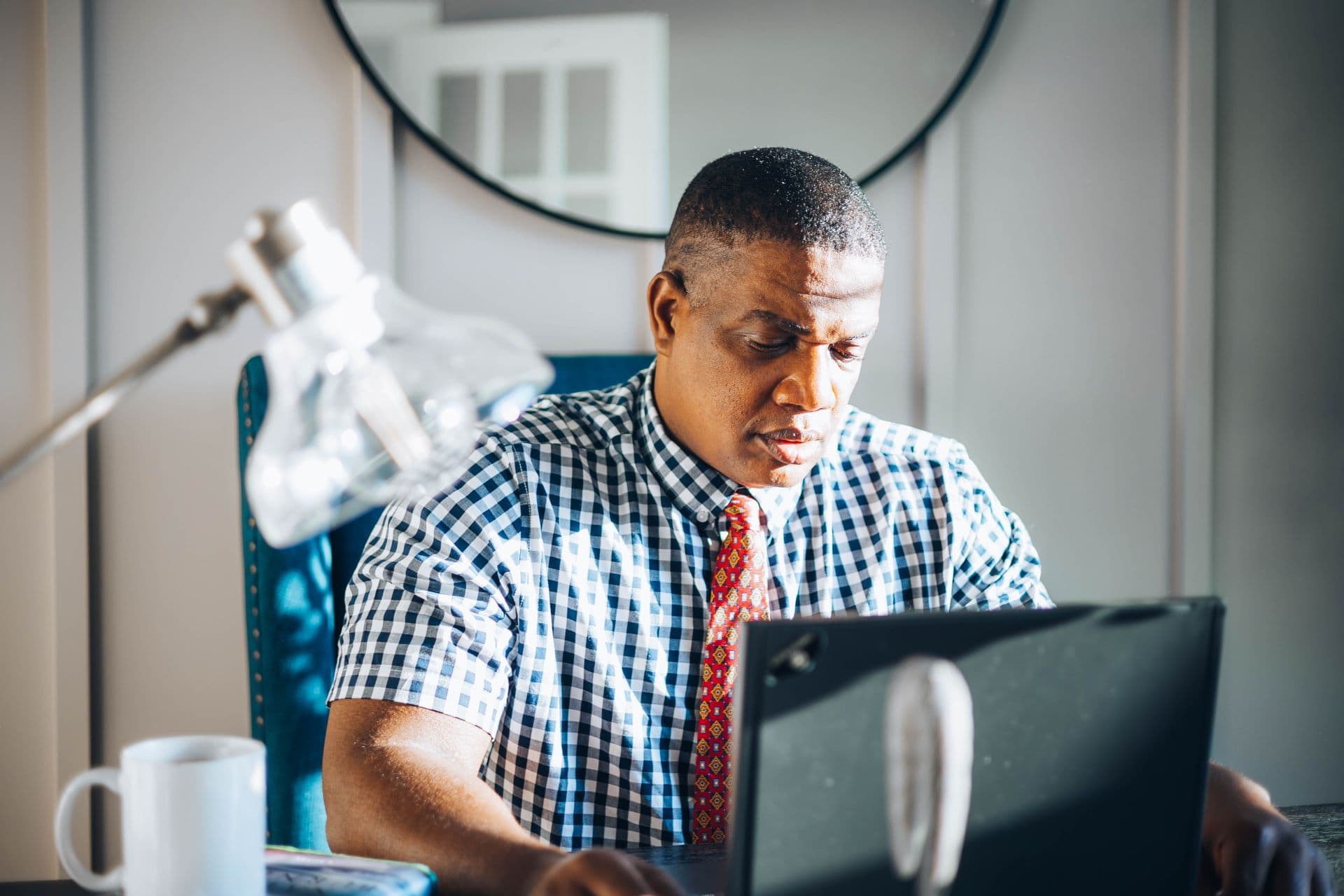 A professional practising at a laptop in a quiet workspace — illustrative stock photo